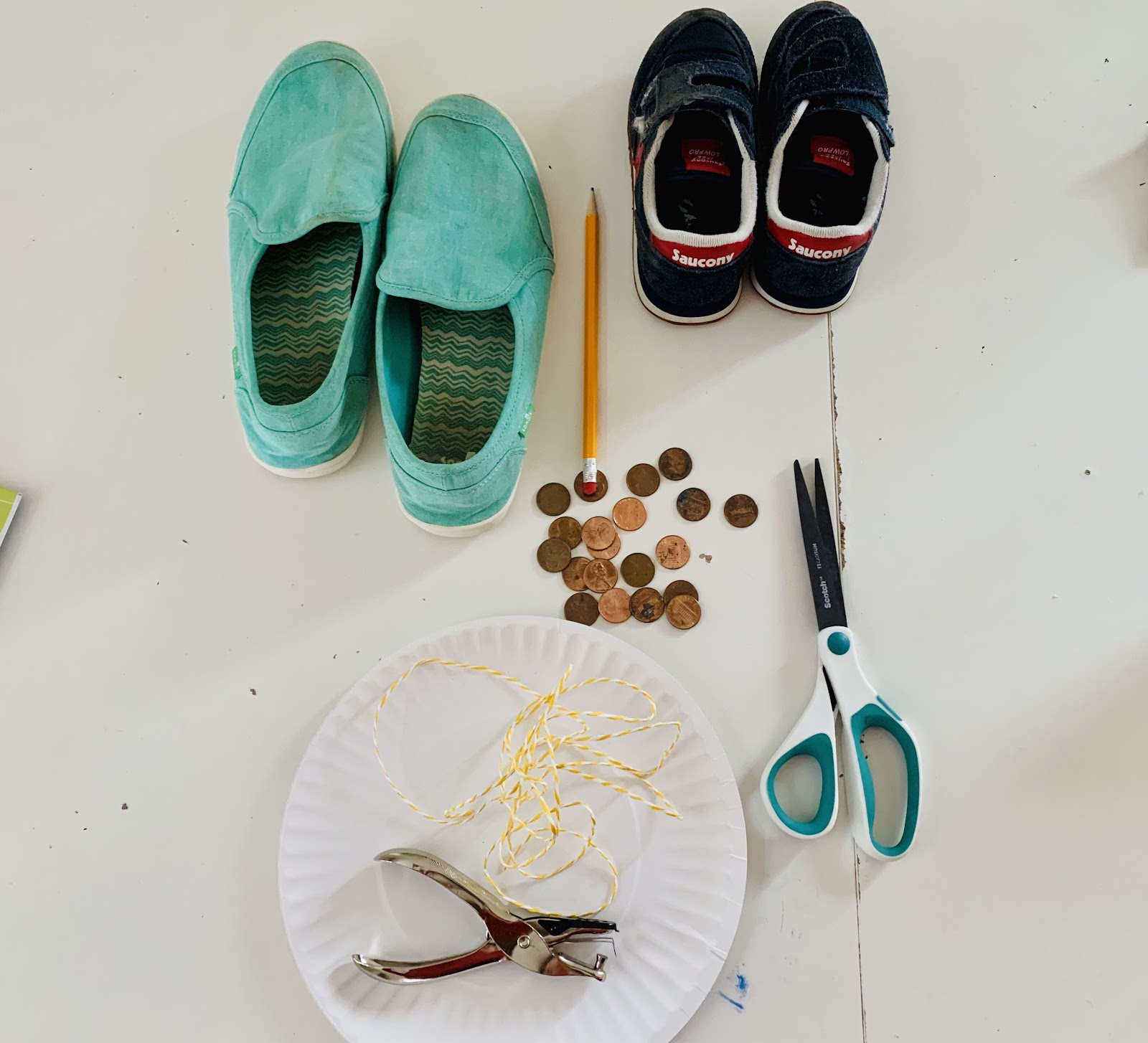 DIY tap dance shoes. Craft supplies: shoes, pennies, paper plate, string, pencil, hole punch, and scissors.
