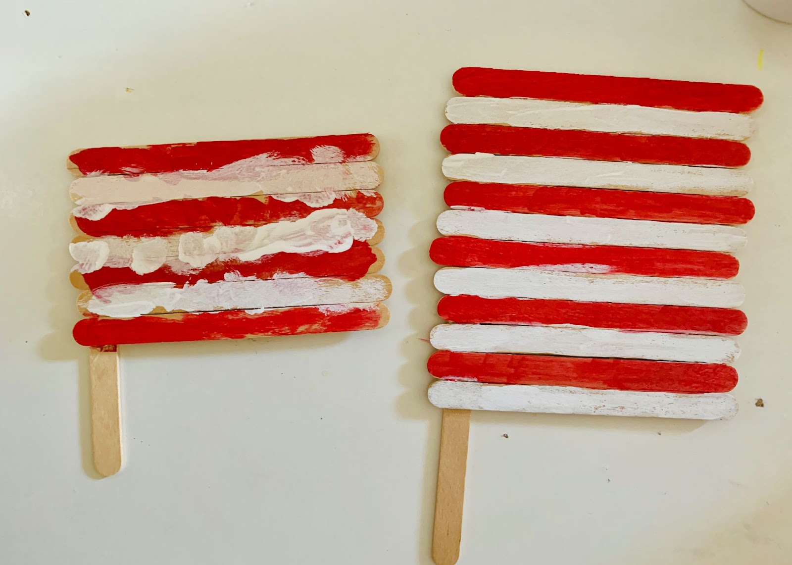 Memorial Day craft: Red and white striped flags made from popsicle sticks. Patriotic DIY project.