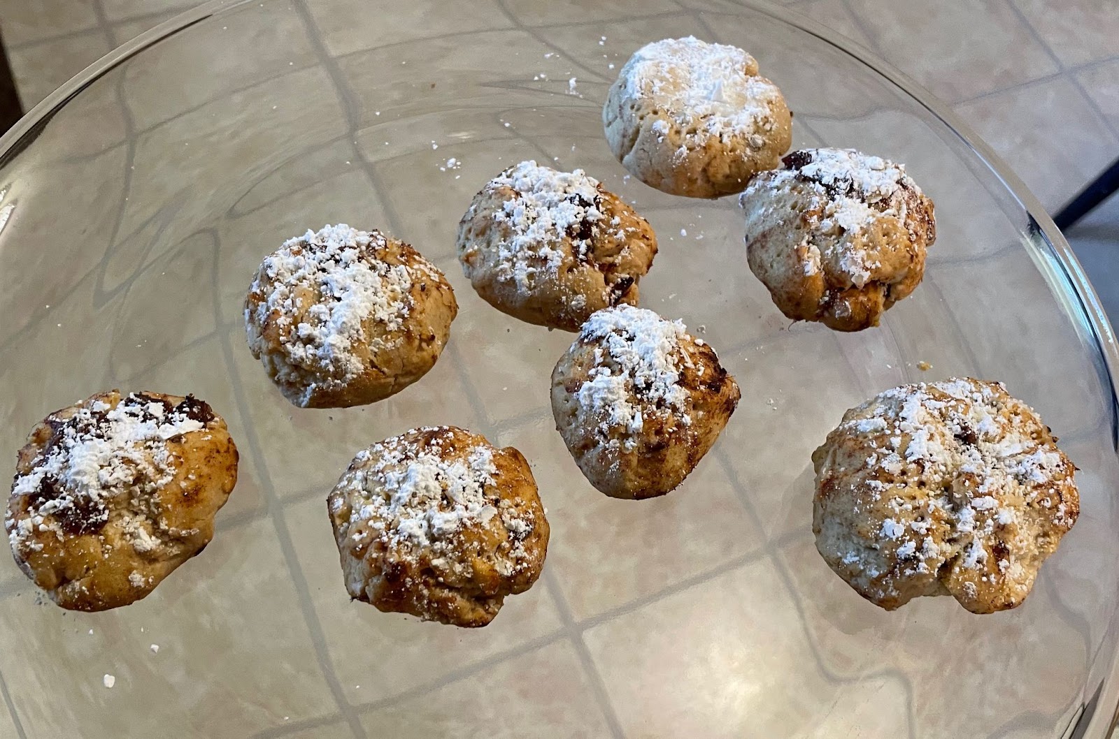 Eid Al-Adha cookies on a glass plate. Holiday dessert with powdered sugar.