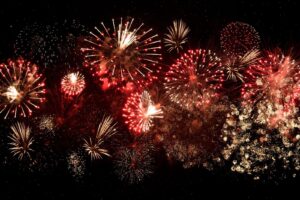 Red and gold fireworks display on black background. 4th of July celebration.