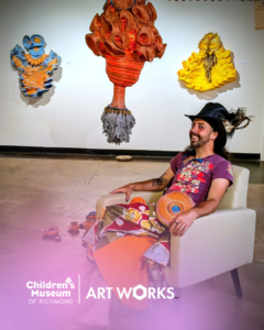 Children's Museum of Richmond: Man seated with art installations. Colorful and creative exhibit, Untitled-design-21.png