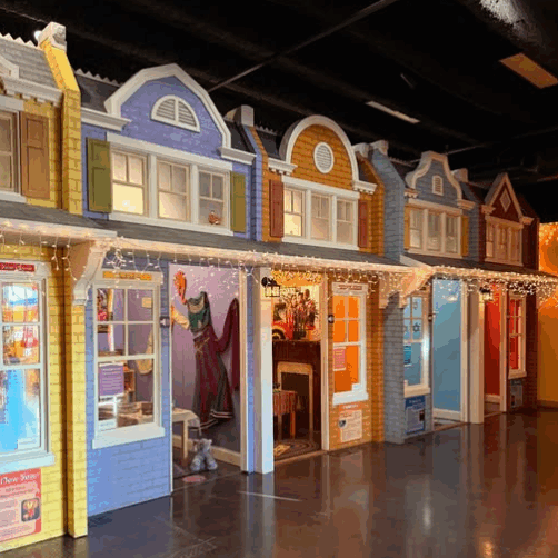 Holiday Village display with colorful miniature houses and festive lights.
