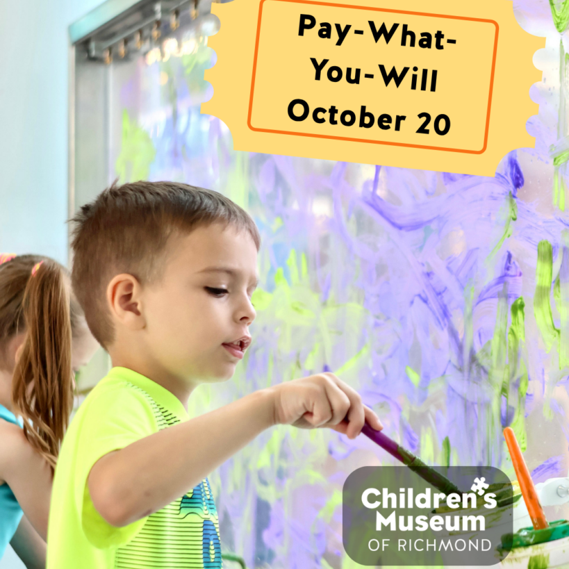 Child paints with a brush on a glass wall at the Children's Museum of Richmond for an artoberVA event.