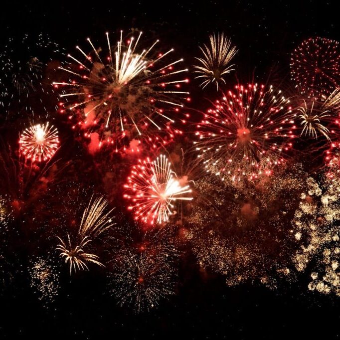 Red and gold fireworks display on black background. 4th of July celebration.